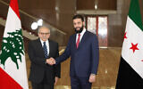Lebanese Prime Minister Nawaf Salam, left, shakes hands with Syrian interim President Ahmed al-Sharaa in Damascus, Syria, on April 14, 2025. (Lebanese Government press office via AP)