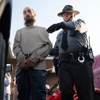 Cody Balmer (left), a suspect in the arson at the home of Pennsylvania Governor Josh Shapiro, is escorted from court after his preliminary arraignment on April 14, 2025, in Harrisburg, Pennsylvania. (AP Photo/Mingson Lau)