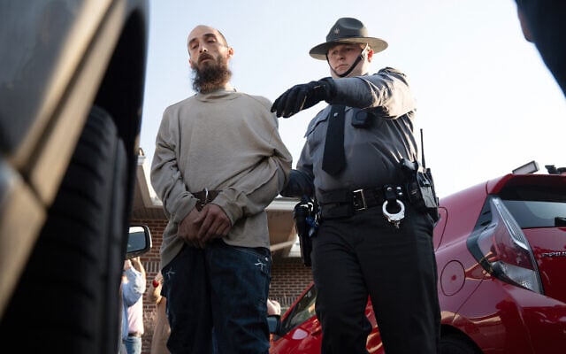Cody Balmer (left), a suspect in the arson at the home of Pennsylvania Governor Josh Shapiro, is escorted from court after his preliminary arraignment on April 14, 2025, in Harrisburg, Pennsylvania. (AP Photo/Mingson Lau)