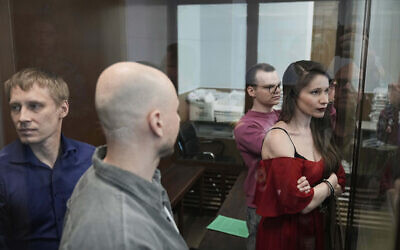 Russian journalists, from left, Konstantin Gabov, Sergey Karelin, Artyom Kriger and Antonina Favorskaya, accused of working for a group founded by the late Russian opposition politician Alexei Navalny, stand in a defendant's cage of the Nagatinsky District Court in Moscow, Russia, Tuesday, April 15, 2025. (AP Photo)