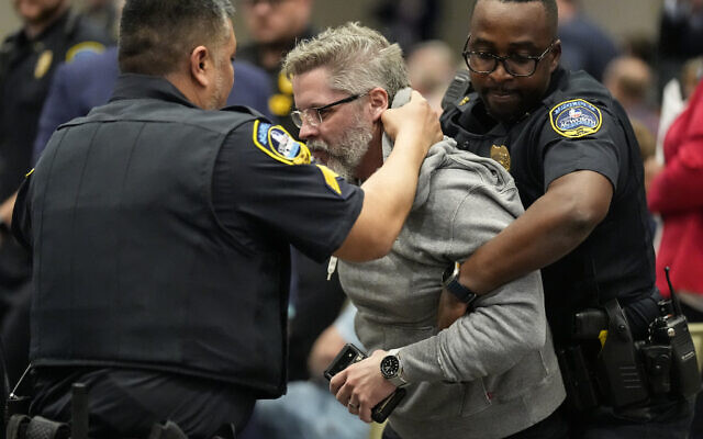 A protester is removed as US Representative Marjorie Taylor Greene speaks during a town-hall style meeting on April 15, 2025, in Acworth, Gorgia. (AP Photo/Mike Stewart) A protester is removed as US Representative Marjorie Taylor Greene speaks during a town-hall style meeting on April 15, 2025, in Acworth, Gorgia. (AP Photo/Mike Stewart)
