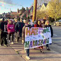 People walk during a march and prayer vigil in Harrisburg, Pennsylvania, April 16, 2025, three days after an arson at the residence of Governor Josh Shapiro in the state capital. (AP Photo/Mark Scolforo)