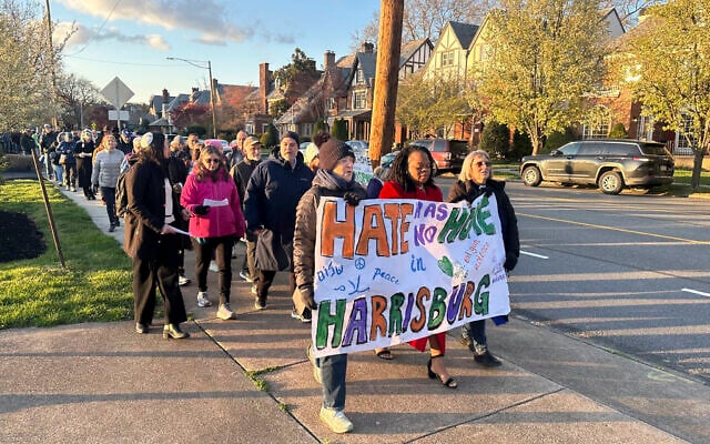 People walk during a march and prayer vigil in Harrisburg, Pennsylvania, April 16, 2025, three days after an arson at the residence of Governor Josh Shapiro in the state capital. (AP Photo/Mark Scolforo)