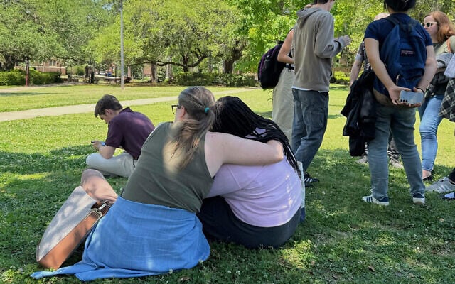People comfort each other on Florida State University’s campus in Tallahassee, where law enforcement responded to a reported active shooter incident, April 17, 2025.  (AP Photo/Kate Payne)