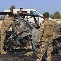 Lebanese army soldiers inspect a charred car that was hit by an Israeli strike, near the coastal city of Sidon, Lebanon, Friday, April 18, 2025. (AP Photo/Mohammed Zaatari)
