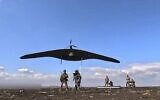 In this photo taken from video distributed by Russian Defense Ministry Press Service on Friday, April 18, 2025, Russian soldiers launch a Supercam intelligence unmanned aerial vehicle towards Ukrainian positions in Ukraine. (Russian Defense Ministry Press Service via AP)