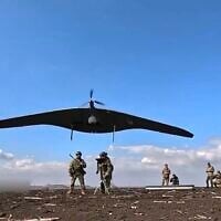 In this photo taken from video distributed by Russian Defense Ministry Press Service on Friday, April 18, 2025, Russian soldiers launch a Supercam intelligence unmanned aerial vehicle towards Ukrainian positions in Ukraine. (Russian Defense Ministry Press Service via AP)