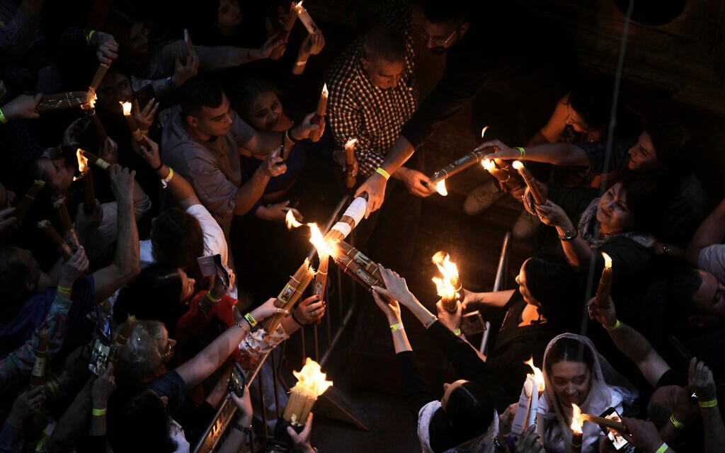 Christian pilgrims light candles during the Holy Fire ceremony, at the Church of the Holy Sepulcher, the site where according to tradition Jesus was crucified and buried, in Jerusalem's Old City, Saturday, April 19, 2025. (AP Photo/Mahmoud Illean)