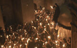Christian pilgrims light candles during the Holy Fire ceremony, at the Church of the Holy Sepulcher, the site where according to tradition Jesus was crucified and buried, in Jerusalem's Old City, Saturday, April 19, 2025. (AP Photo/Mahmoud Illean)
