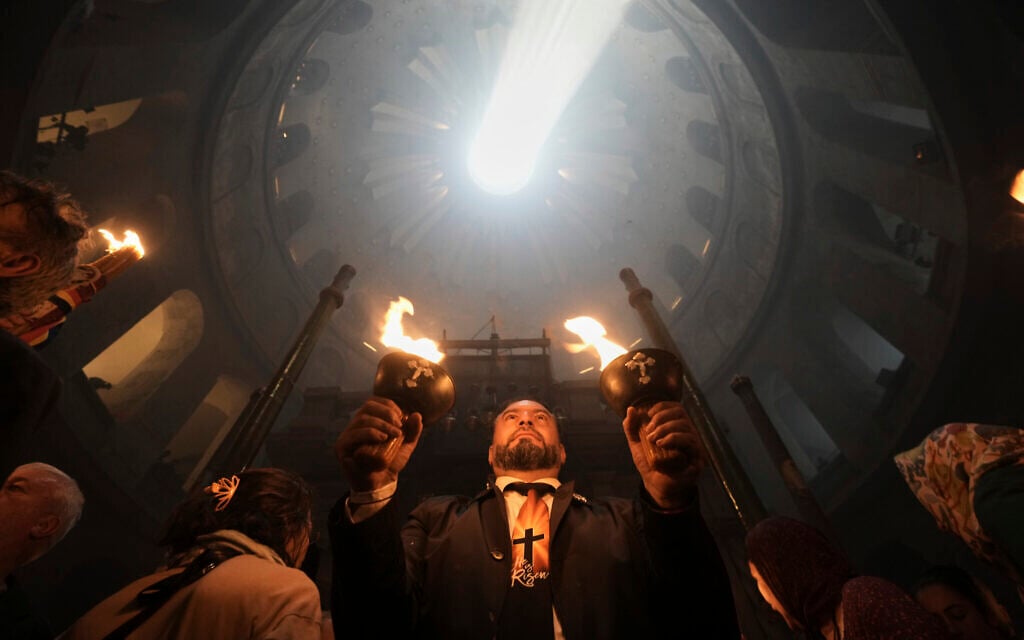 Christian pilgrims hold candles during the Holy Fire ceremony, at the Church of the Holy Sepulcher, the site where according to tradition Jesus was crucified and buried, in Jerusalem's Old City, Saturday, April 19, 2025. (AP Photo/Mahmoud Illean)