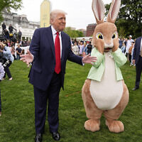 US President Donald Trump stands with the Easter bunny as he participates in the White House Easter Egg Roll on the South Lawn of the White House, Monday, April 21, 2025, in Washington. (AP Photo/Mark Schiefelbein)