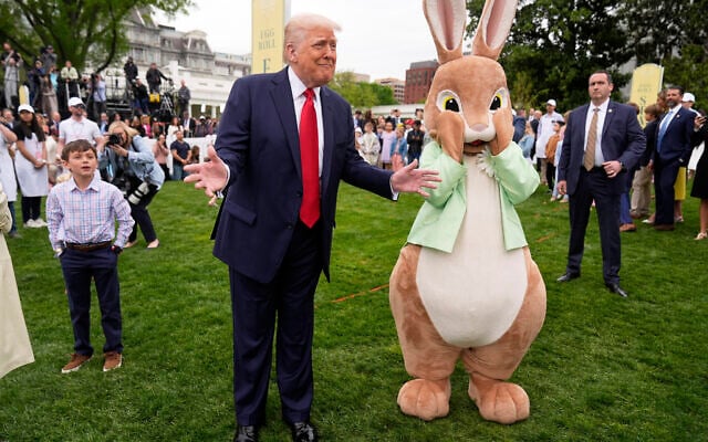 US President Donald Trump, left, stands with the Easter bunny during the the White House Easter Egg Roll on the South Lawn of the White House in Washington, April 21, 2025. (AP Photo/Mark Schiefelbein)