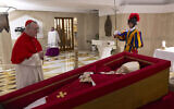 Vatican Secretary of State Cardinal Pietro Parolin, left, prays in front of the body of Pope Francis laid out in state inside his private chapel at the Vatican, April 21, 2025. (Vatican Media via AP, HO)