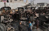 Palestinians examine the remains of bulldozers hit by an Israeli army airstrike in Jabaliya, northern Gaza Strip, on Tuesday, April 22, 2025. (AP Photo/Jehad Alshrafi)