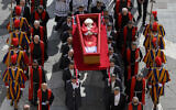 The body of late Pope Francis is carried in an open coffin through St. Peter's Square to St. Peter's Basilica at the Vatican on Wednesday, April 23, 2025, where the deceased pontiff will lie in state for three days. (Vatican Media via AP)