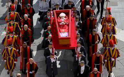The body of late Pope Francis is carried in an open coffin through St. Peter's Square to St. Peter's Basilica at the Vatican on Wednesday, April 23, 2025, where the deceased pontiff will lie in state for three days. (Vatican Media via AP)