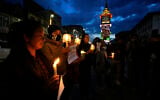 People hold candles during a candlelight protest in Srinagar, Indian controlled Kashmir, April 23, 2025, a day after an attack killed at least 26 people, most of them tourists. (AP/Mukhtar Khan)