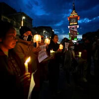 People hold candles during a candlelight protest in Srinagar, Indian controlled Kashmir, April 23, 2025, a day after an attack killed at least 26 people, most of them tourists. (AP/Mukhtar Khan)