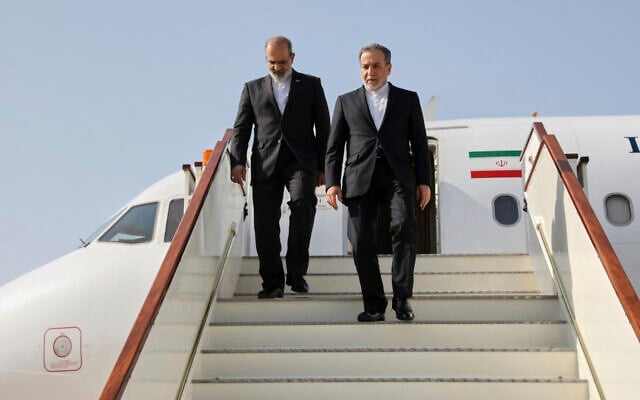 In this photo released by Iranian Foreign Ministry, Iranian Foreign Minister Abbas Araghchi, right, steps out from his plane as he arrives at Muscat, Oman, Friday, April 25, 2025, a day prior to negotiations with US Mideast envoy Steve Witkoff. (Iranian Foreign Ministry via AP)