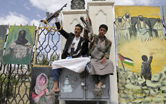 Houthi supporters chant slogans in front of banners supporting Palestinians, during anti-US and anti-Israel rally in Sanaa, Yemen, April 25, 2025. (AP Photo/Osamah Abdulrahman)