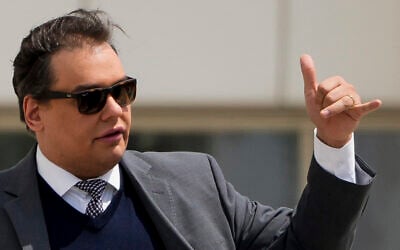 Former US Rep. George Santos leaves federal court after being sentenced to more than seven years in prison for fraud and identity theft, Friday, April 25, 2025, in Central Islip, N.Y. (AP Photo/Julia Demaree Nikhinson)