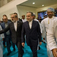 Iranian Foreign Minister Abbas Araghchi, center, visits the Muscat International Book Fair in Oman, April 25, 2025. (Fatima Shbair/AP)