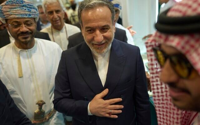 Iranian Foreign Minister Abbas Araghchi, center, and Omani Foreign Minister Badr al-Busaidi, left, walk through the Muscat International Book Fair in Oman, April 25, 2025. (AP Photo/Fatima Shbair)
