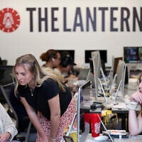Emma Wozniak, editor in chief of the Ohio State University's The Lantern newspaper, talks with Nora Igelnik, campus editor at the paper's office in Columbus, Ohio, April 24, 2025, as managing editor of content, Lucy Lawler listens. (AP Photo/Joe Maiorana)