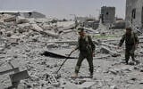 Yemeni soldiers inspect the damage reportedly caused by U.S. airstrikes in Sanaa, Yemen, April 27, 2025. (AP Photo/Osamah Abdulrahman)