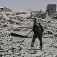 Yemeni soldiers inspect the damage reportedly caused by U.S. airstrikes in Sanaa, Yemen, April 27, 2025. (AP Photo/Osamah Abdulrahman)