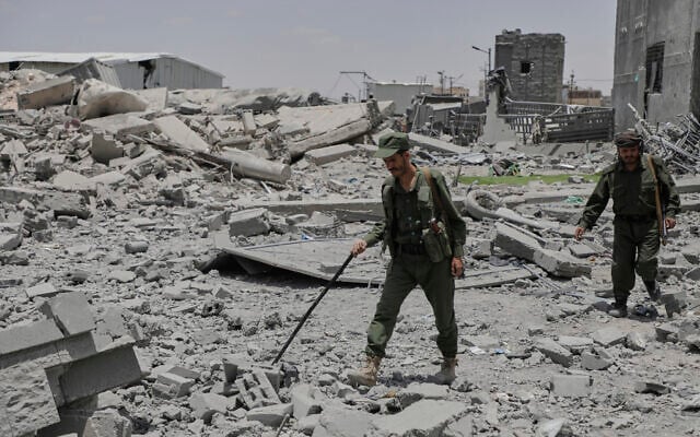 Yemeni soldiers inspect the damage reportedly caused by U.S. airstrikes in Sanaa, Yemen, April 27, 2025. (AP Photo/Osamah Abdulrahman)