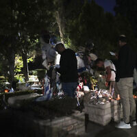 People visit Mount Herzl military cemetery in Jerusalem on the eve of Israel's annual Memorial Day for the fallen soldiers, Tuesday, April 29, 2025. (AP Photo/Ohad Zwigenberg)