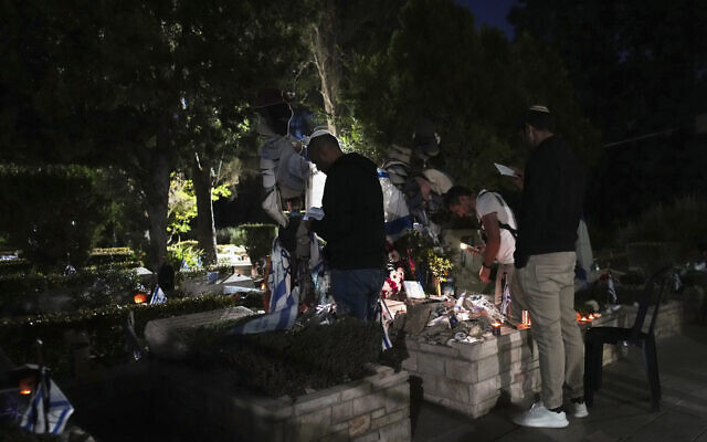 People visit Mount Herzl military cemetery in Jerusalem on the eve of Israel's annual Memorial Day for the fallen soldiers, Tuesday, April 29, 2025. (AP Photo/Ohad Zwigenberg)