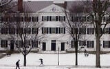 FILE - In this file photo from January 2001, students walk to-and-from classes in front of Dartmouth Hall in Hanover, New Hampshire. (AP Photo/Jim Cole, File)
