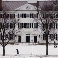 FILE - In this file photo from January 2001, students walk to-and-from classes in front of Dartmouth Hall in Hanover, New Hampshire. (AP Photo/Jim Cole, File)
