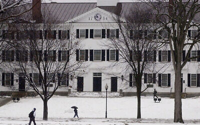 FILE - In this file photo from January 2001, students walk to-and-from classes in front of Dartmouth Hall in Hanover, New Hampshire. (AP Photo/Jim Cole, File)