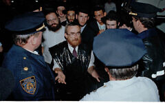 Orthodox Jews talk to police about more police presence to prevent further violence during anti-Jewish riots in the Crown Heights section of Brooklyn, New York, August 21, 1991. (AP Photo/Andrew Savulich)
