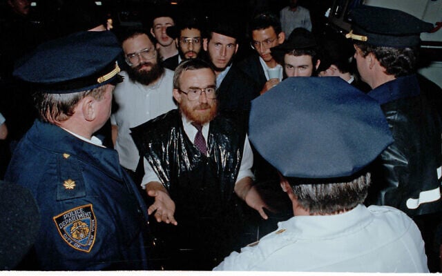 Orthodox Jews talk to police about more police presence to prevent further violence during anti-Jewish riots in the Crown Heights section of Brooklyn, New York, August 21, 1991. (AP Photo/Andrew Savulich)