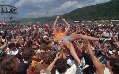 A woman is carried over the crowd at the Lollapalooza concert in Pownal, Vermont,  July 9, 1996. (AP Photo/Toby Talbot)