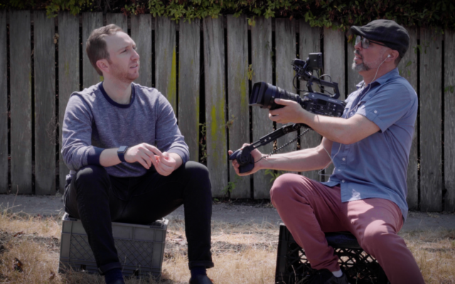 Filmmaker Yoav Potash filming Aaron Friedman Tartakovksy, whose family came from Gniewoszów, Poland, the central element in 'Among Neighbors,' Potash's documentary about a Polish town, screened in Israel for Holocaust Remembrance Day, starting April 23, 2025 (Courtesy)