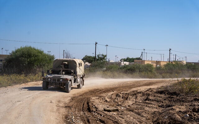 IDF vehicles drive outside the Zikim training base in southern Israel, November 16, 2023. (Emanuel Fabian/Times of Israel)