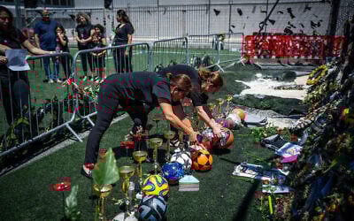 Classmates and teachers of Druze children killed in a deadly missile attack at a soccer field in the Druze village of Majdal Shams, in the Golan Heights, visit the site, August 2, 2024. (Erik Marmor/Flash90)