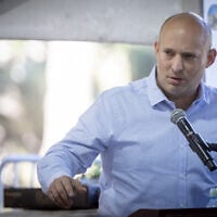 Former prime minister Naftali Bennett speaks at a commemoration marking 30 days since the death of Yona Brif, who was injured fighting invading terrorists during the Hamas onslaught of October 7, 2023, and succumbed to his wounds a year later, at the Mt. Herzal military cemetery in Jerusalem. December 25, 2024. (Chaim Goldberg/Flash90)