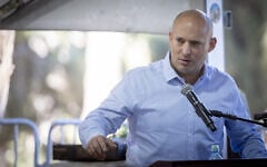 Former prime minister Naftali Bennett speaks at a commemoration marking 30 days since the death of Yona Brif, who was injured fighting invading terrorists during the Hamas onslaught of October 7, 2023, and succumbed to his wounds a year later, at the Mt. Herzal military cemetery in Jerusalem. December 25, 2024. (Chaim Goldberg/Flash90)
