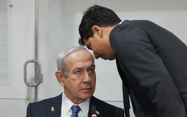 Lawyer Amit Hadad speaks to Prime Minister Benjamin Netanyahu in the courtroom of Tel Aviv District Court, March 31, 2025. (Miriam Alster/Flash90) Lawyer Amit Hadad speaks to Prime Minister Benjamin Netanyahu in the courtroom of Tel Aviv District Court, March 31, 2025. (Miriam Alster/Flash90)