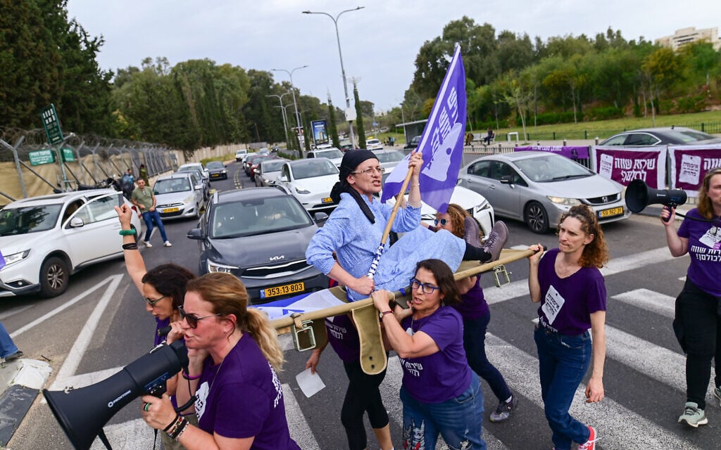 Activists protest calling for equality in the military service, outside the IDF Recruitment Center at Tel Hashomer in central Israel, April 1, 2025. (Tomer Neuberg/Flash90)