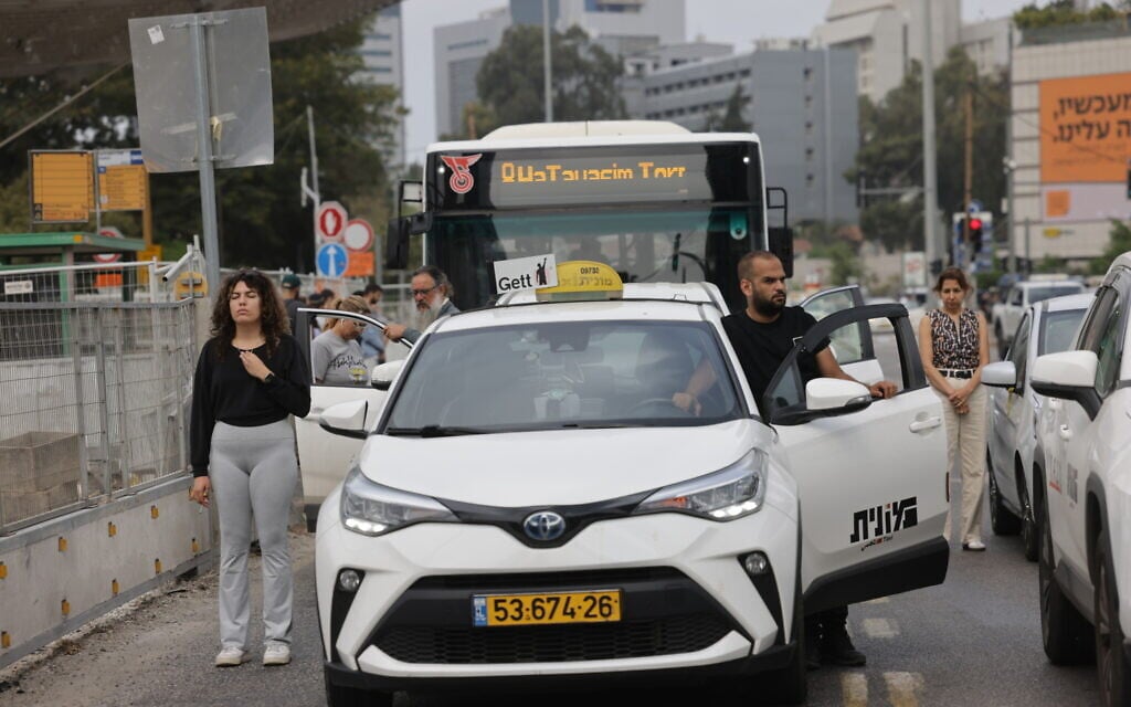 People stand still in Tel Aviv as a two-minute siren is sounded across Israel to mark Holocaust Remembrance Day on April 24, 2025. (Miriam Alster/Flash90)