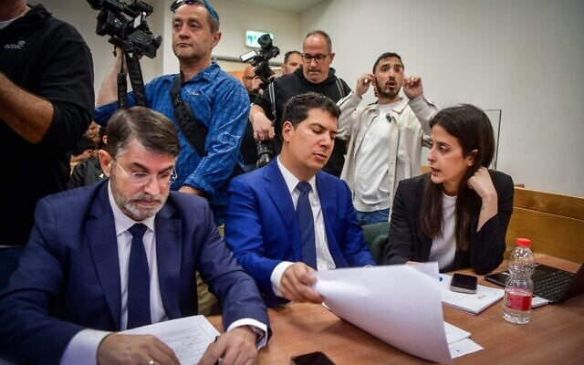 Eli Feldstein's attorney Oded Savoray (left), Jonatan Urich's attorney Amit Hadad (center) and other attorneys attend a court hearing at which police asked to extend the remand of Prime Minister Benjamin Netanyahu's aides Urich and Feldstein amid the ongoing Qatargate investigation, at the Rishon LeZion Magistrate's Court, April 3, 2025. (Avshalom Sassoni/Flash90)