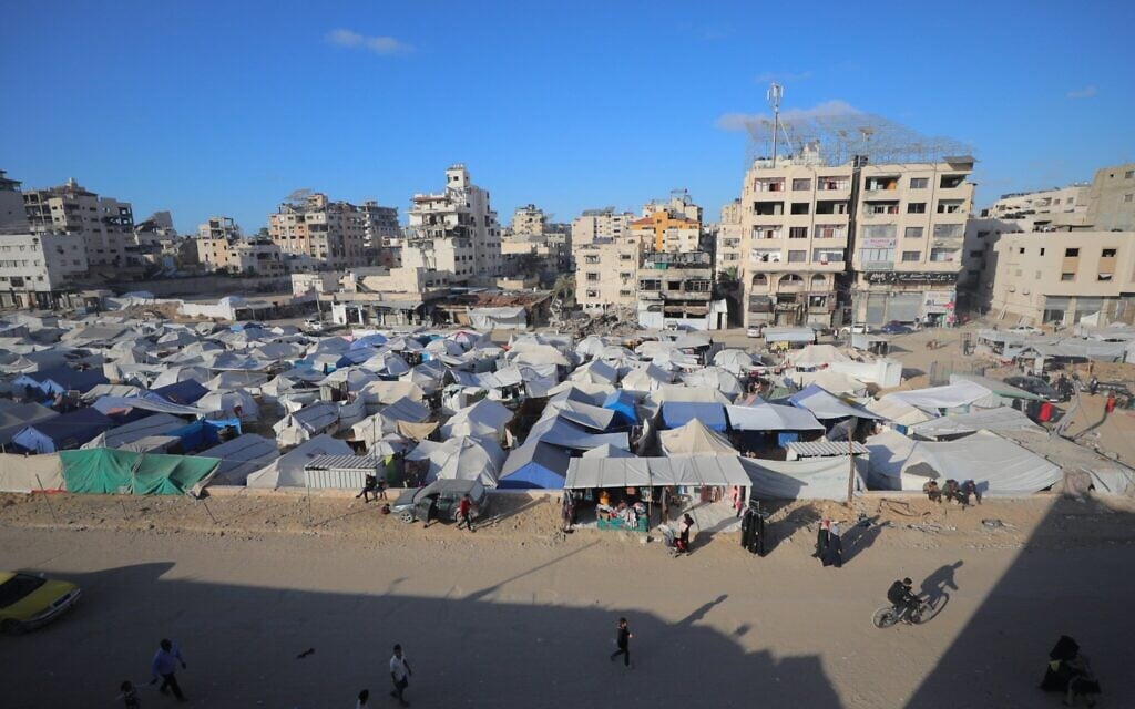 Displaced Palestinians seen near their tents in the Jundi al-Majwal area in Gaza City, April 4, 2025. (Ali Hassan/Flash90)