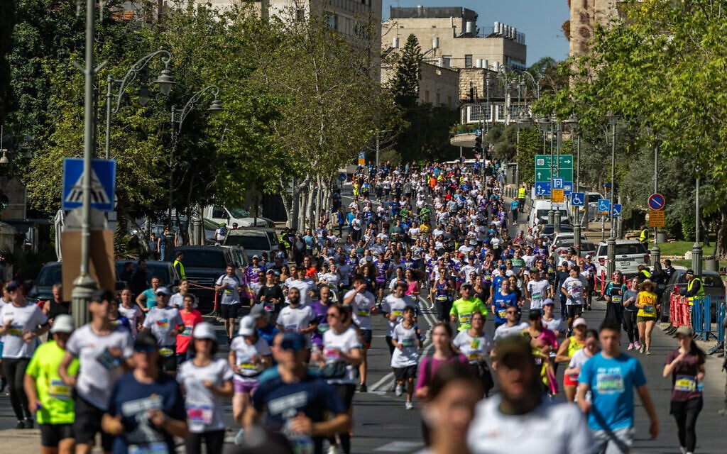 Thousands of runners take part in the annual Jerusalem marathon on Jaffa street in Jerusalem, on April 4, 2025. (Yonatan Sindel/Flash90)